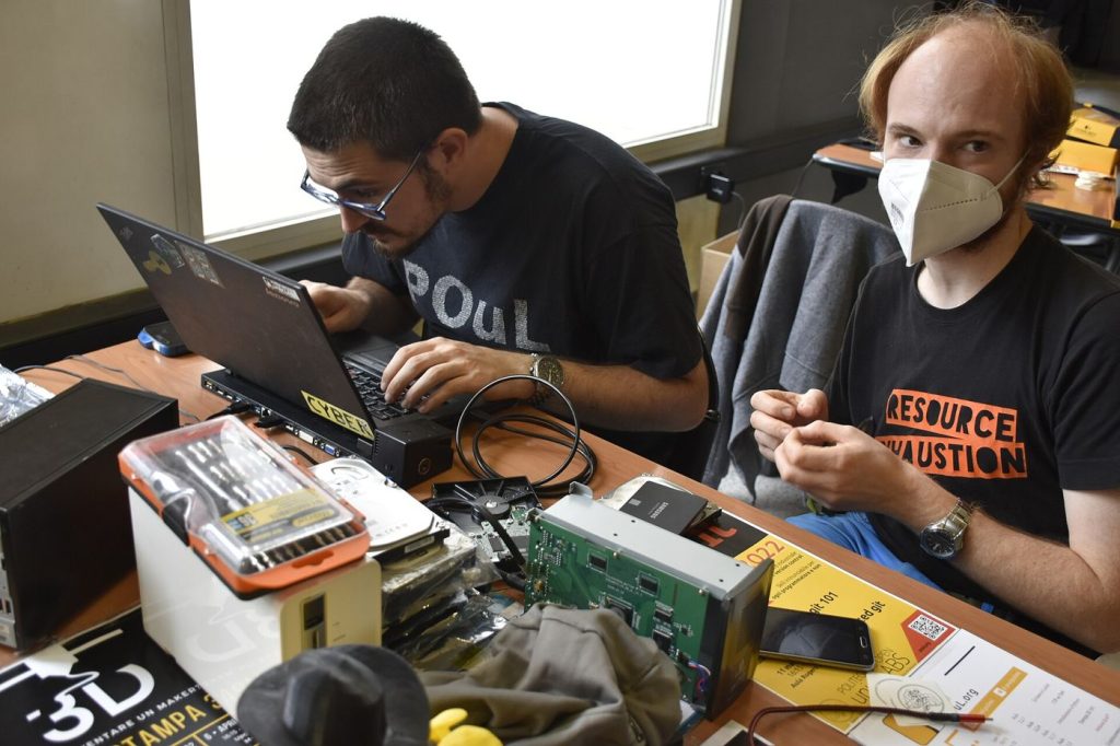 A laptop being repaired on a workbench