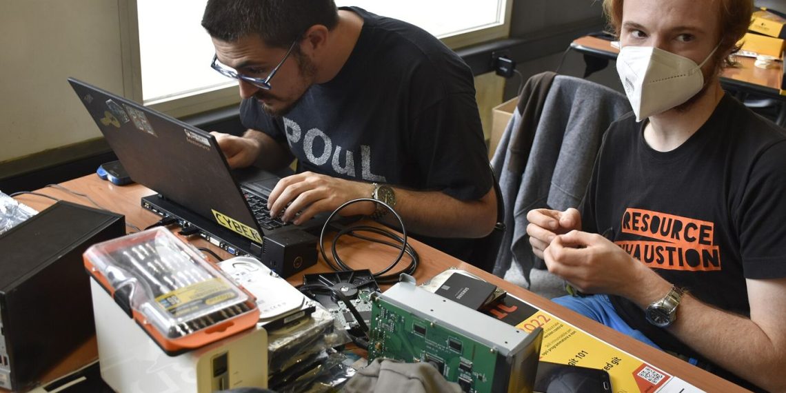 A laptop being repaired on a workbench