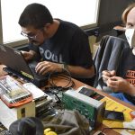 A laptop being repaired on a workbench