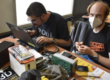A laptop being repaired on a workbench