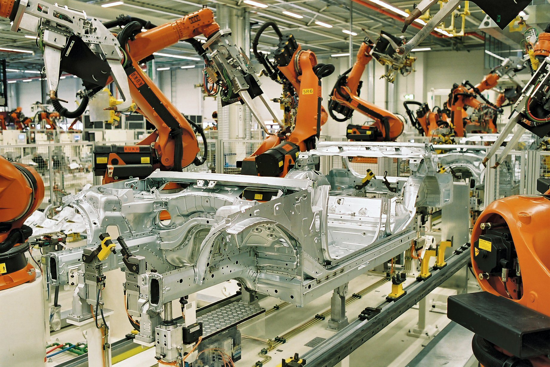 Workers assembling electric vehicles on a production line at a factory in Asia