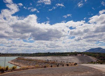 The Mekong river flowing past a hydropower dam with dry banks visible in the foreground